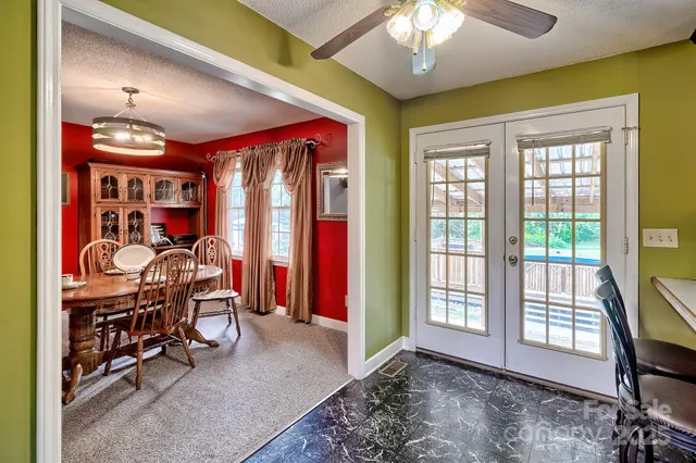 a kitchen with stainless steel appliances granite countertop a sink dishwasher stove and refrigerator with wooden floor