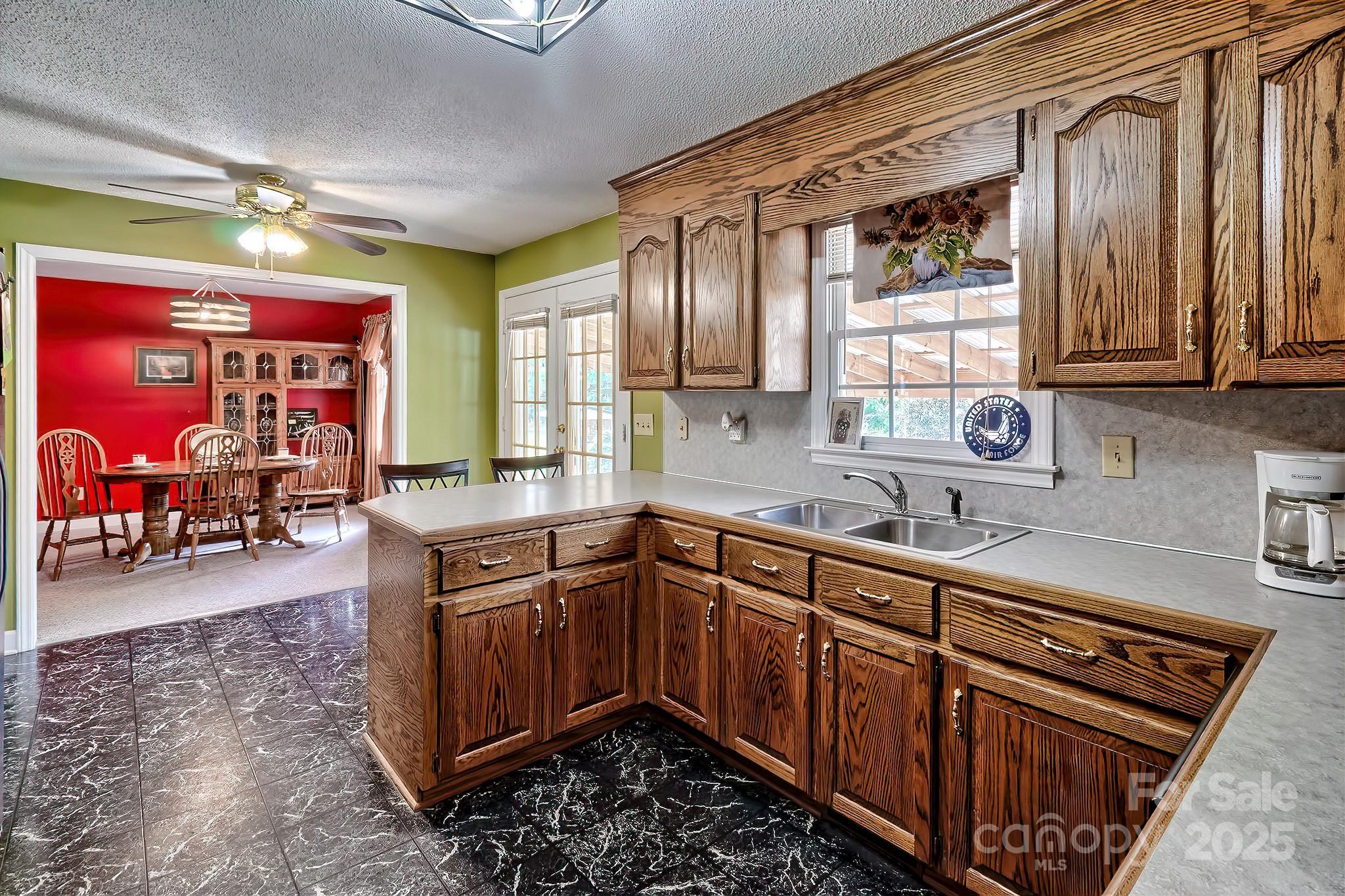 176 Griffin Road Pageland, SC 29728 - Photo 29 of 46 a kitchen with stainless steel appliances granite countertop a sink stove and wooden cabinets