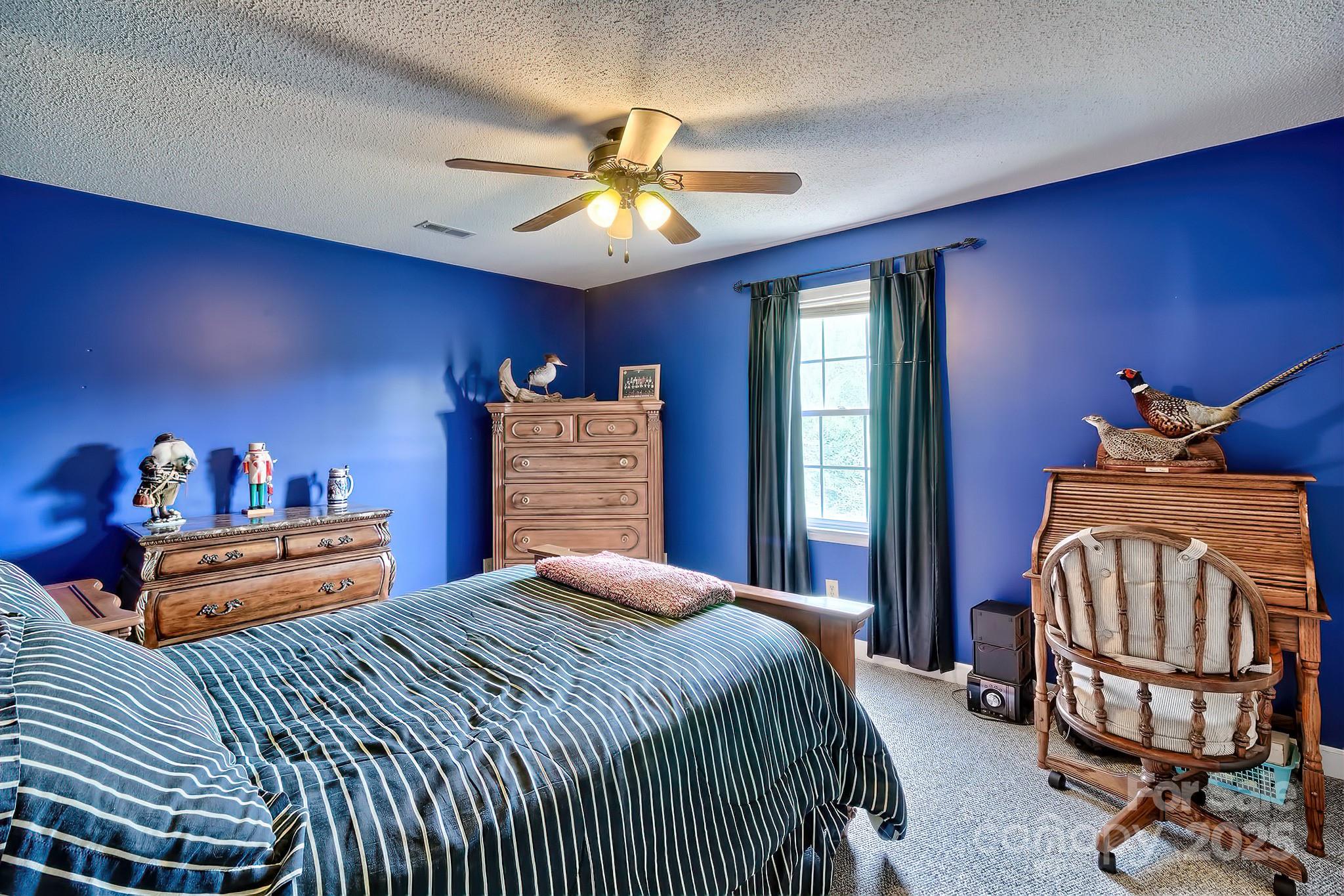 176 Griffin Road Pageland, SC 29728 - Photo 37 of 46 a bedroom with a bed and a chandelier