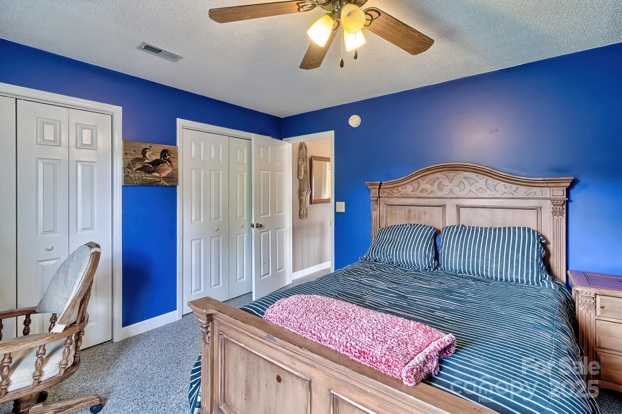 176 Griffin Road Pageland, SC 29728 - Photo 38 of 46 a bedroom with a bed and a chandelier