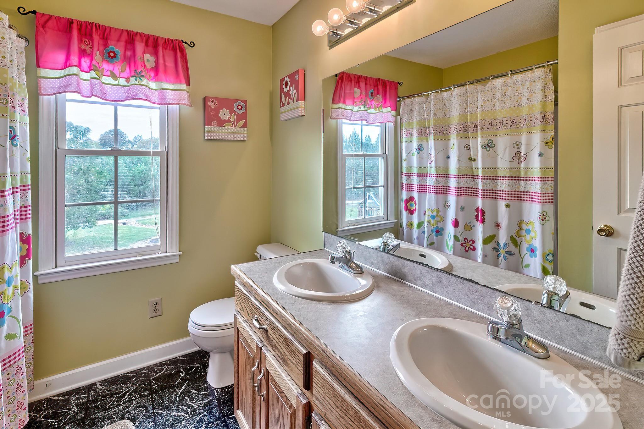 176 Griffin Road Pageland, SC 29728 - Photo 39 of 46 a bathroom with a granite countertop bathtub sink vanity mirror and toilet