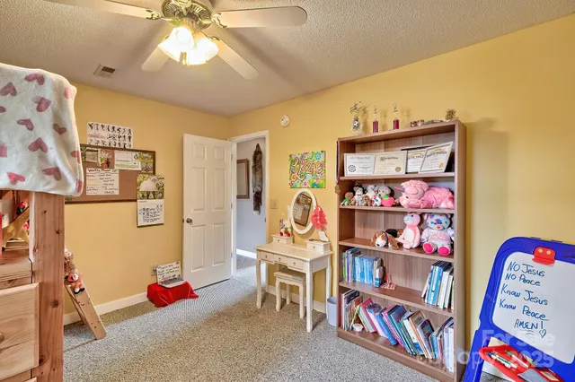 a living room with furniture and a ceiling fan