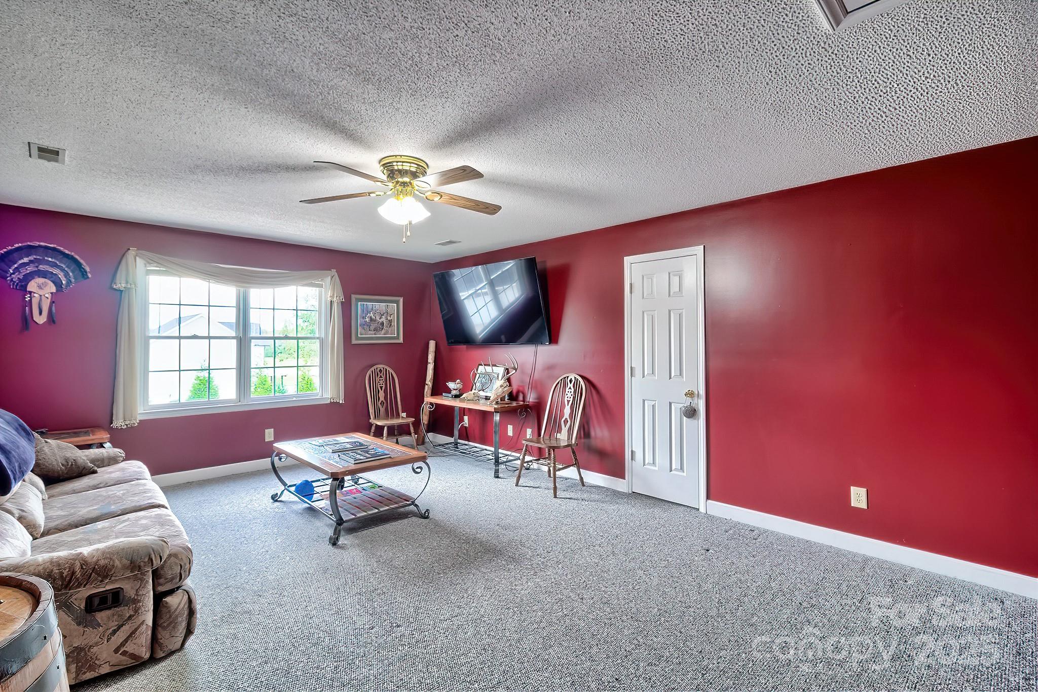 176 Griffin Road Pageland, SC 29728 - Photo 42 of 46 a living room with furniture and a chandelier