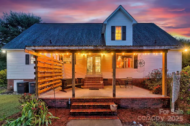 a backyard of a house with table and chairs