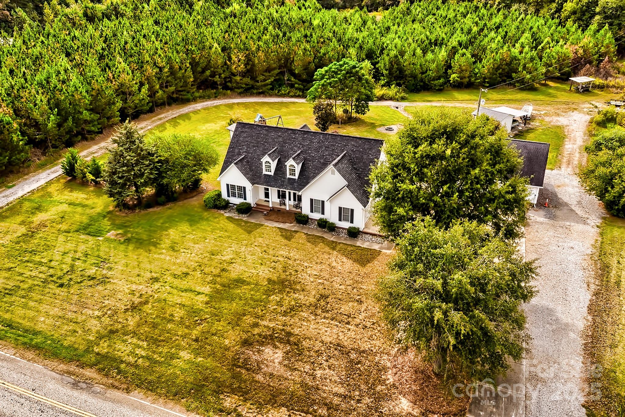 176 Griffin Road Pageland, SC 29728 - Photo 10 of 46 a view of a swimming pool with an outdoor space and seating area