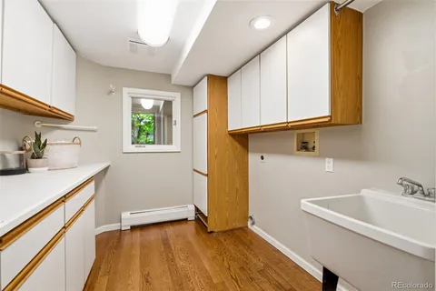 a view of a kitchen with a sink and wooden floor