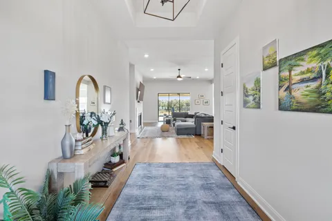 a view of a hallway with a chandelier