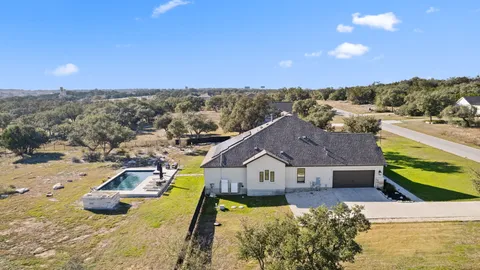a view of a house with swimming pool and sitting area