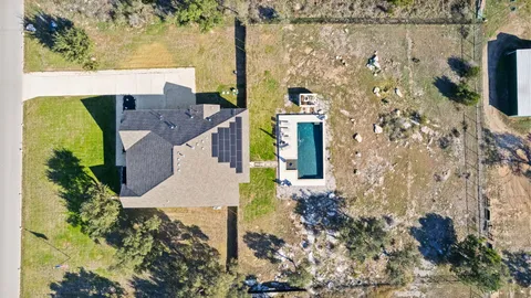an aerial view of a house with a big yard