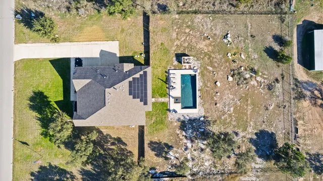 an aerial view of a house with a big yard