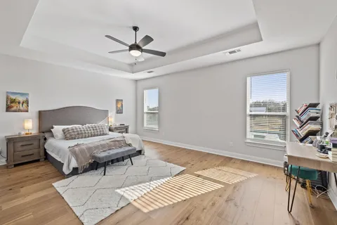 a view of a dining room with furniture large windows and wooden floor