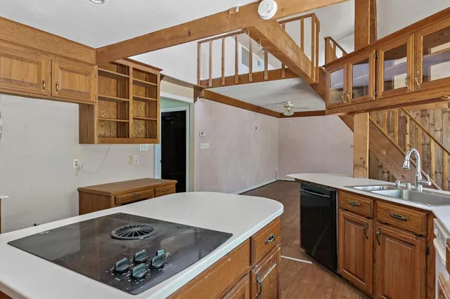 a kitchen with stainless steel appliances a stove a sink dishwasher and cabinets