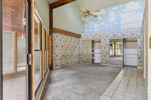 a view of a hallway with closet and chandelier