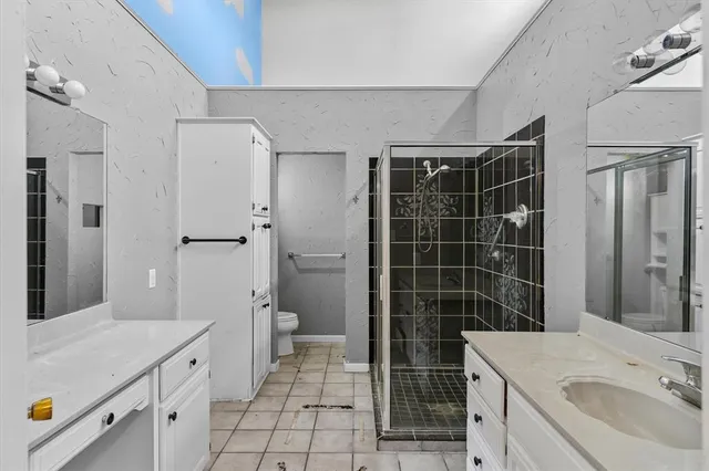 a bathroom with a sink toilet and shower