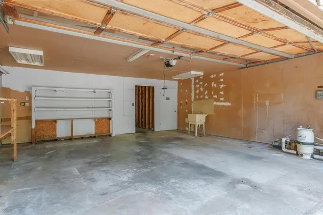 a view of a livingroom with a refrigerator and a window