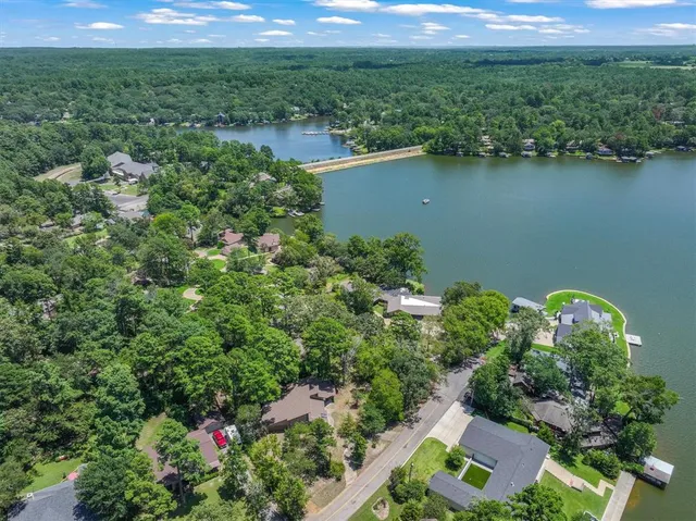 an aerial view of a house and lake view
