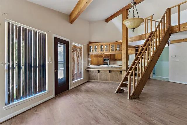 a view of entryway with stairs and wooden floor