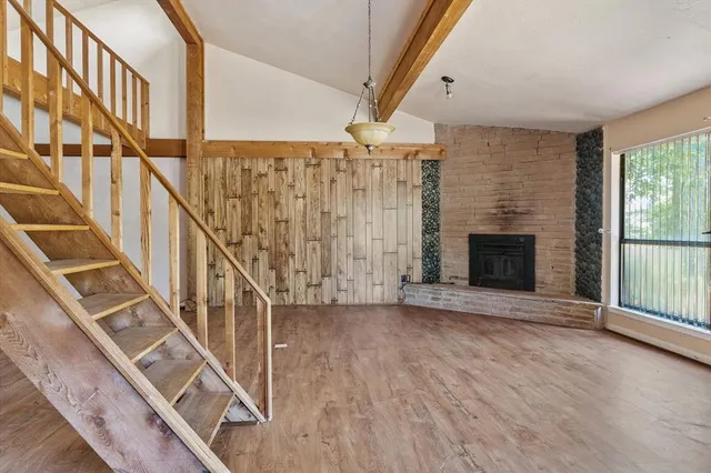 a view of an entryway with wooden floor