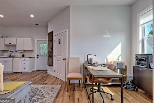 a view of a hallway with furniture and a window