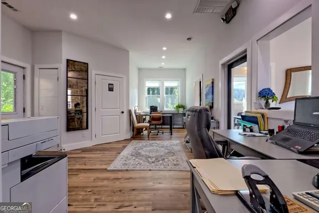a view of a terrace with wooden floor barbeque oven and outdoor seating