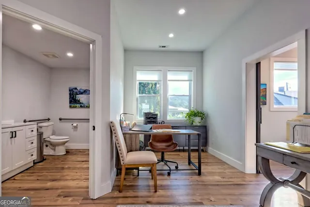 a living room with furniture and a floor to ceiling window