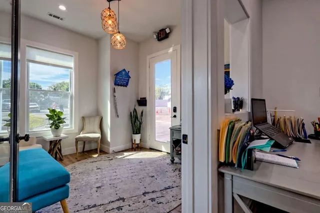 a view of a dining room with furniture and wooden floor