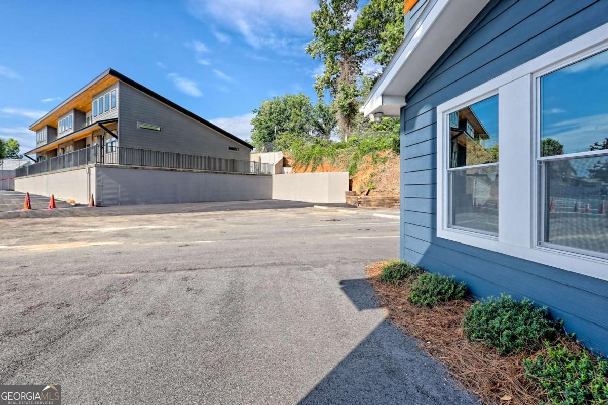 25 Valley Street Clayton, GA 30525 - Photo 29 of 81 a front view of a house with a yard and garage