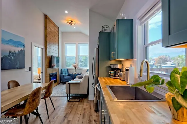 a balcony view with two chairs and a table