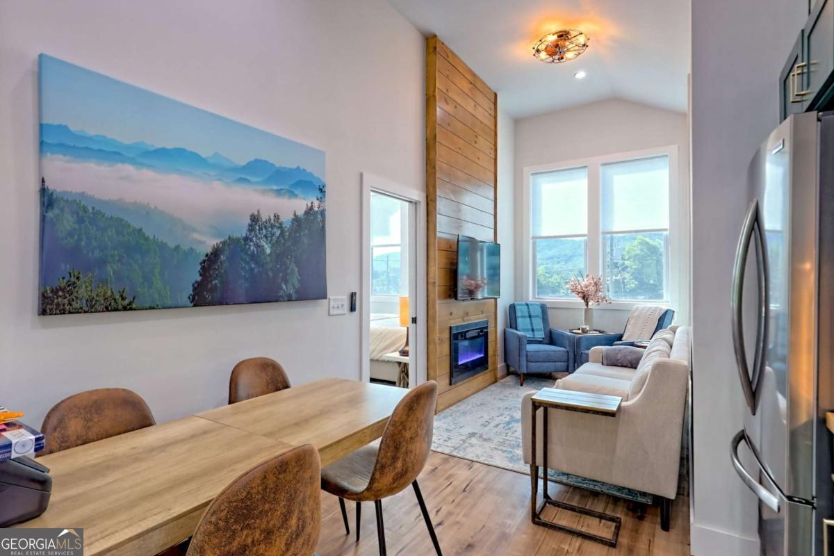 25 Valley Street Clayton, GA 30525 - Photo 39 of 81 a living room with furniture and a floor to ceiling window