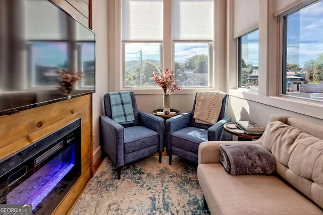 an aerial view of residential houses with outdoor space and trees