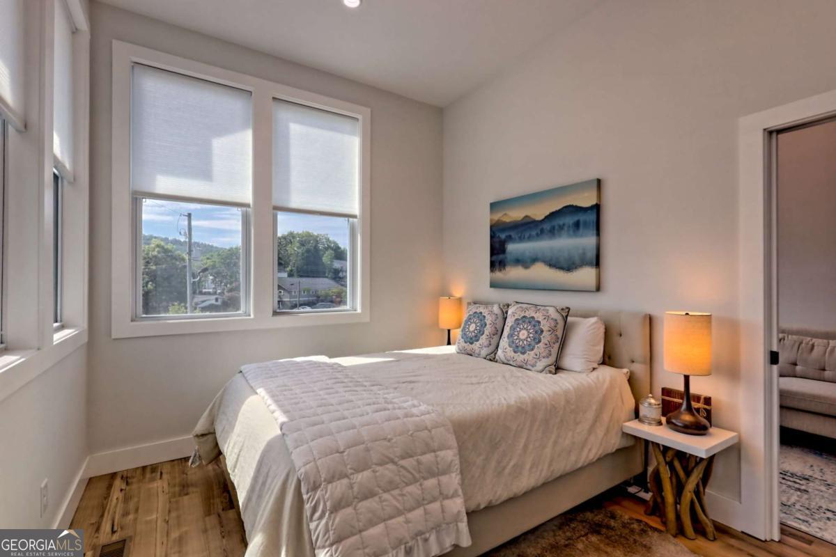 25 Valley Street Clayton, GA 30525 - Photo 46 of 81 a bedroom with a bed a flat tv screen and a dresser