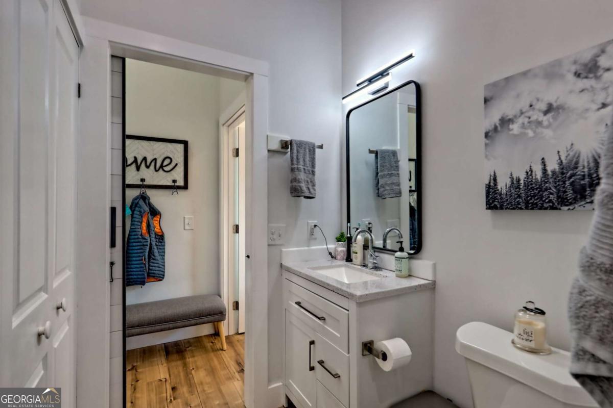 25 Valley Street Clayton, GA 30525 - Photo 50 of 81 a bathroom with a toilet sink and mirror