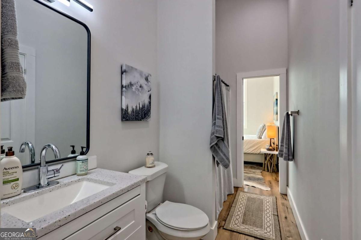 25 Valley Street Clayton, GA 30525 - Photo 51 of 81 a bathroom with a toilet a sink and mirror