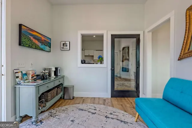 a view of a dining room with furniture a chandelier and wooden floor