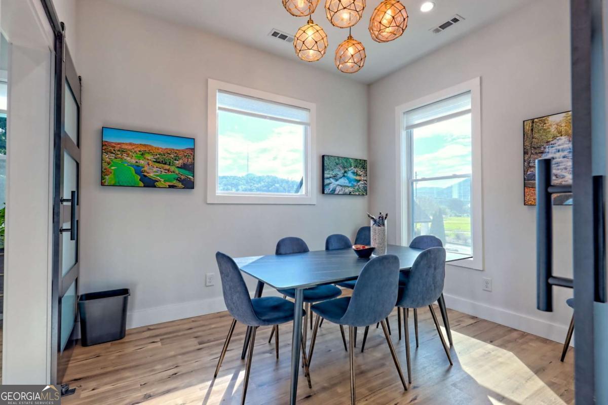 25 Valley Street Clayton, GA 30525 - Photo 9 of 81 a view of a dining room with furniture a chandelier and wooden floor
