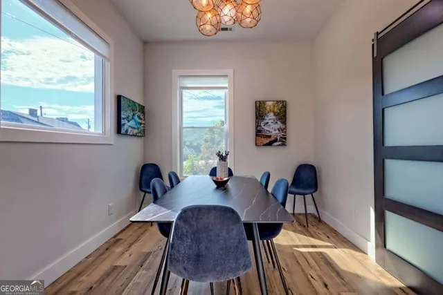 a view of a dining room with furniture and wooden floor