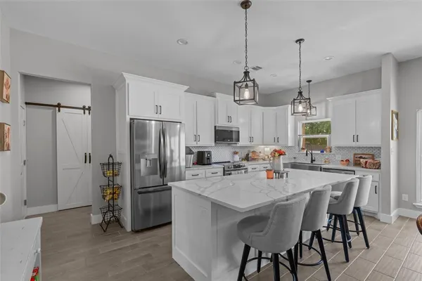 a view of kitchen center island and stainless steel appliances