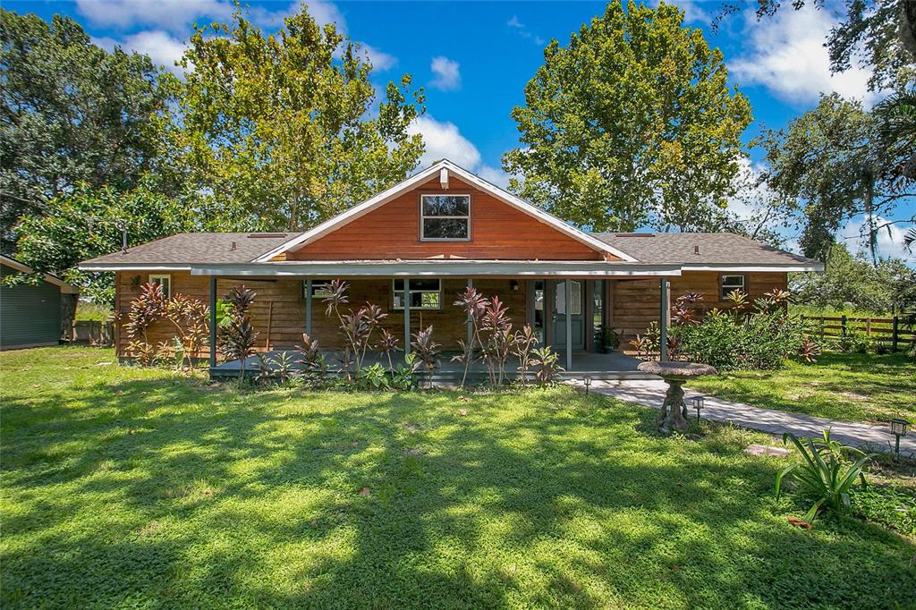 a front view of a house with swimming pool having outdoor seating
