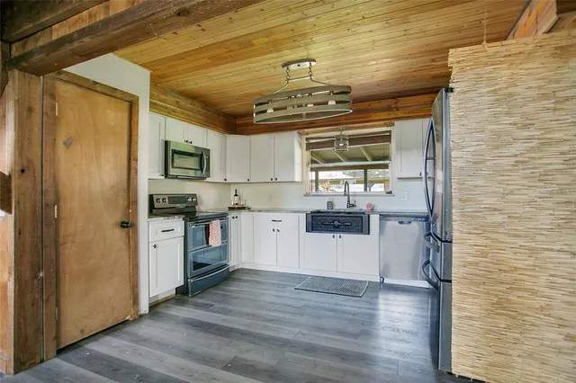 a kitchen with a refrigerator and a sink