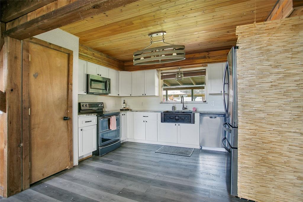 35 South Lake Fox Road Winter Haven, FL 33884 - Photo 11 of 43 a kitchen with a refrigerator and a sink