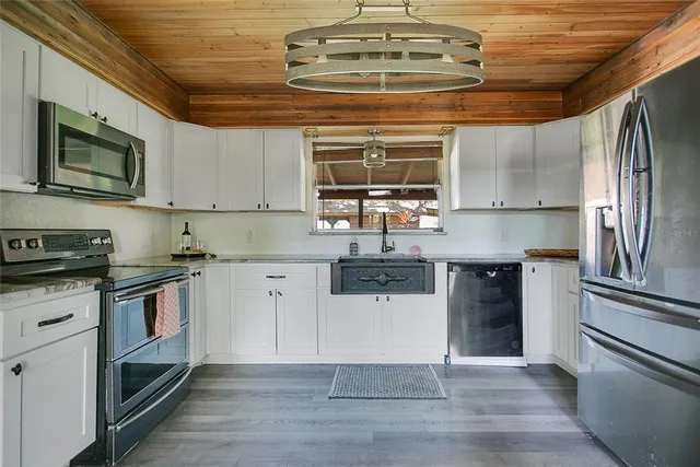 a kitchen with stainless steel appliances granite countertop a stove and a sink