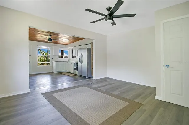 a view of a kitchen with a sink and a refrigerator