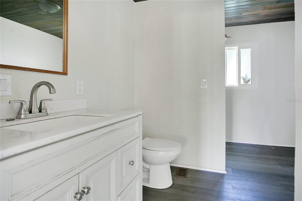 35 South Lake Fox Road Winter Haven, FL 33884 - Photo 17 of 43 a bathroom with a toilet a sink and mirror