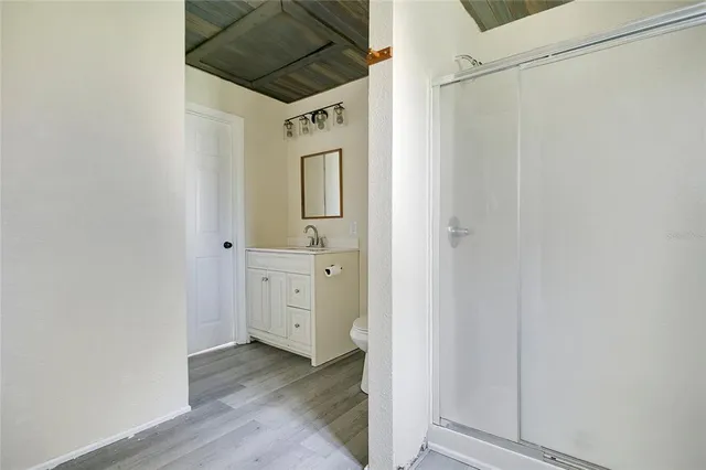 a view of a hallway with wooden floor