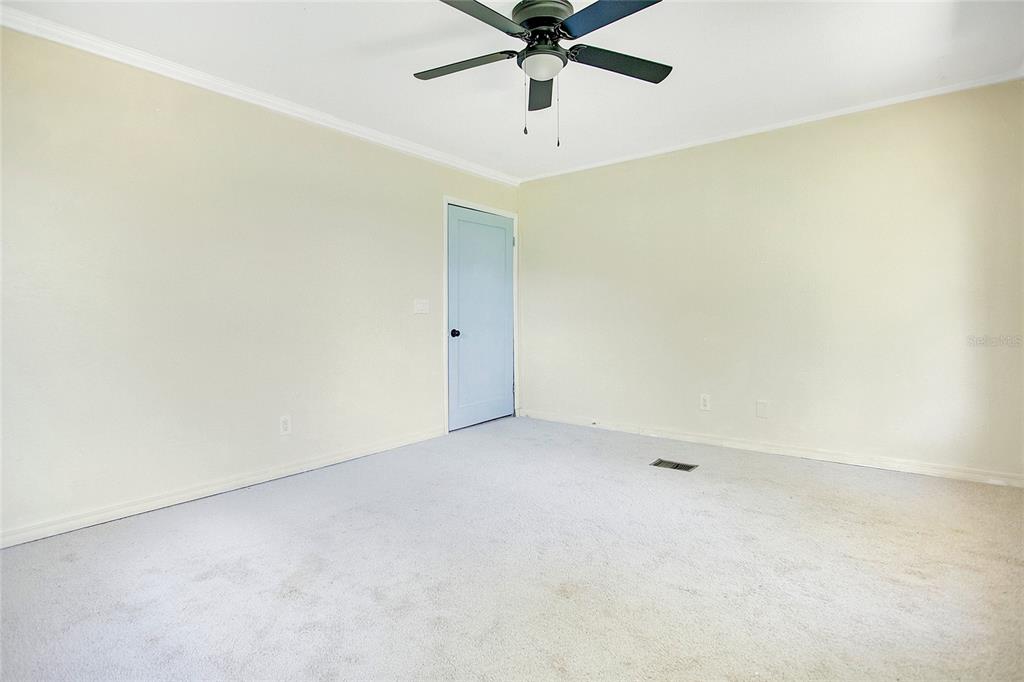 35 South Lake Fox Road Winter Haven, FL 33884 - Photo 20 of 43 an empty room with a ceiling fan and carpet