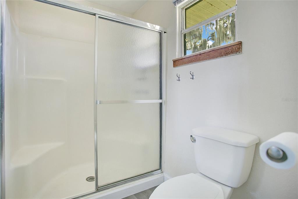 35 South Lake Fox Road Winter Haven, FL 33884 - Photo 22 of 43 a white toilet sitting next to a shower