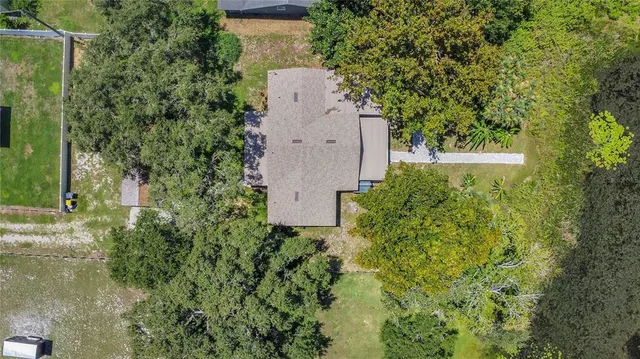 an aerial view of a house with a yard and garden