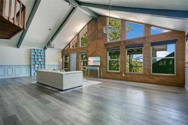 a view of an entryway with wooden floor and windows