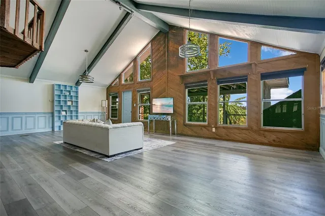 a view of an entryway with wooden floor and windows