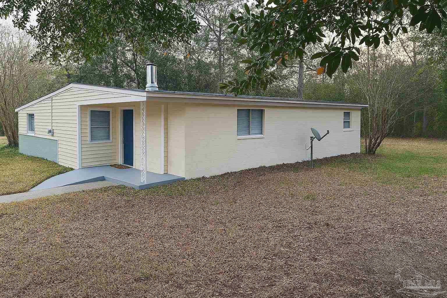 6274 Munson Highway Milton, FL 32570 - Photo 1 of 26 a house with trees in the background